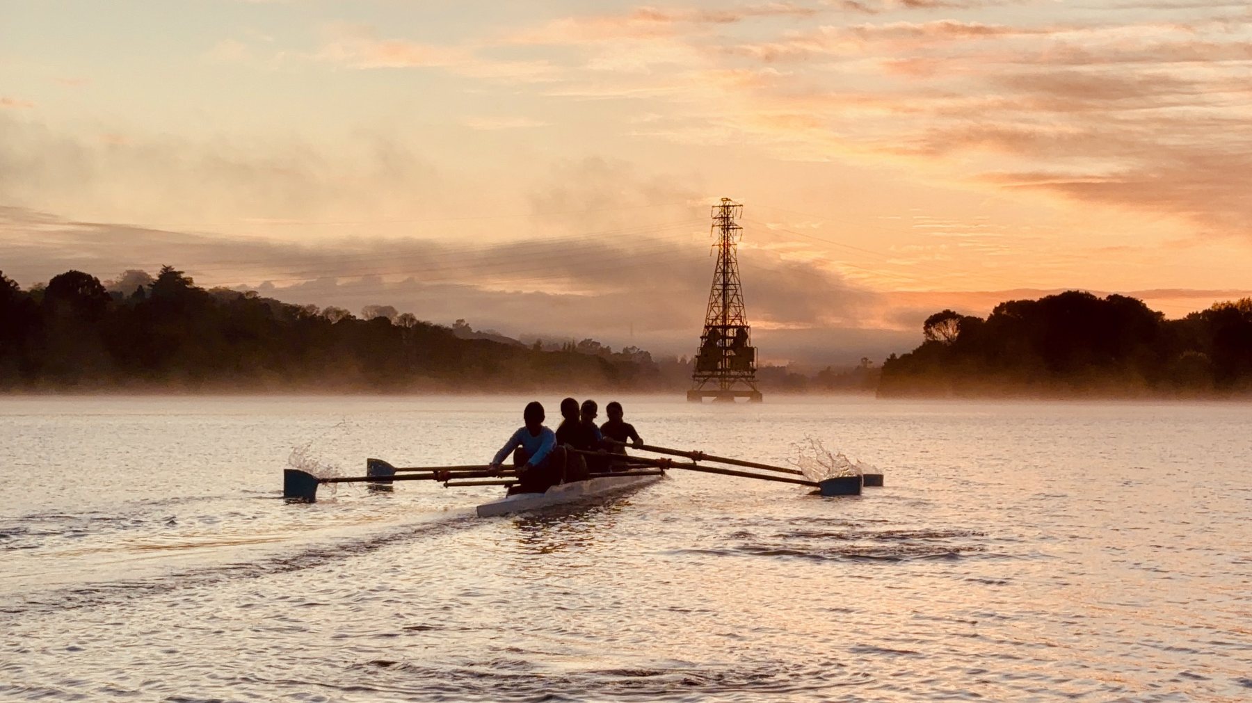 Rowing crew training at sunrise